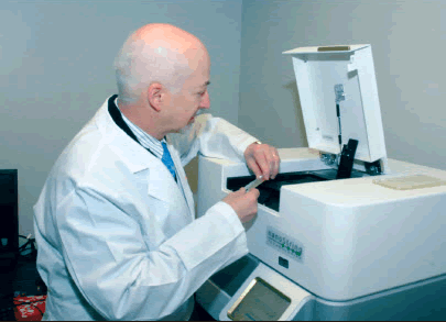 A male scientists conducts research using the Nanostring nCounter analysis system.