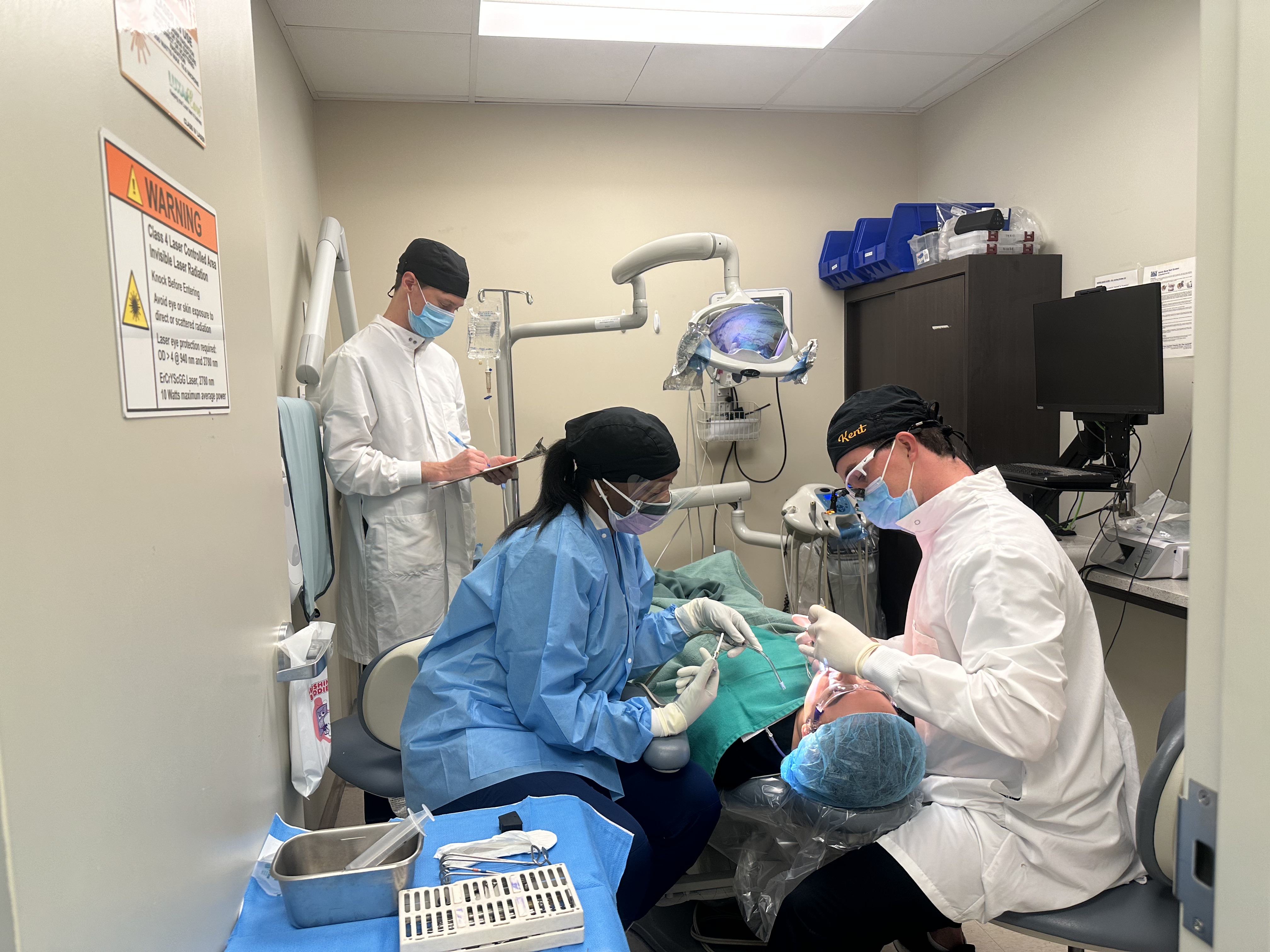 Periodotics graduate students performing a surgery.