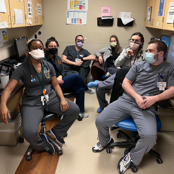 Residents in masks sitting in an office