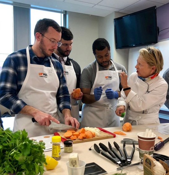 Residents in a kitchen learning about culinary medicine