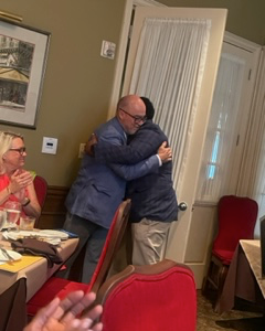 Resident and faculty hugging at the 2023 graduation