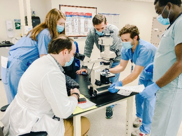 Residents looking at specimen in a hospital setting