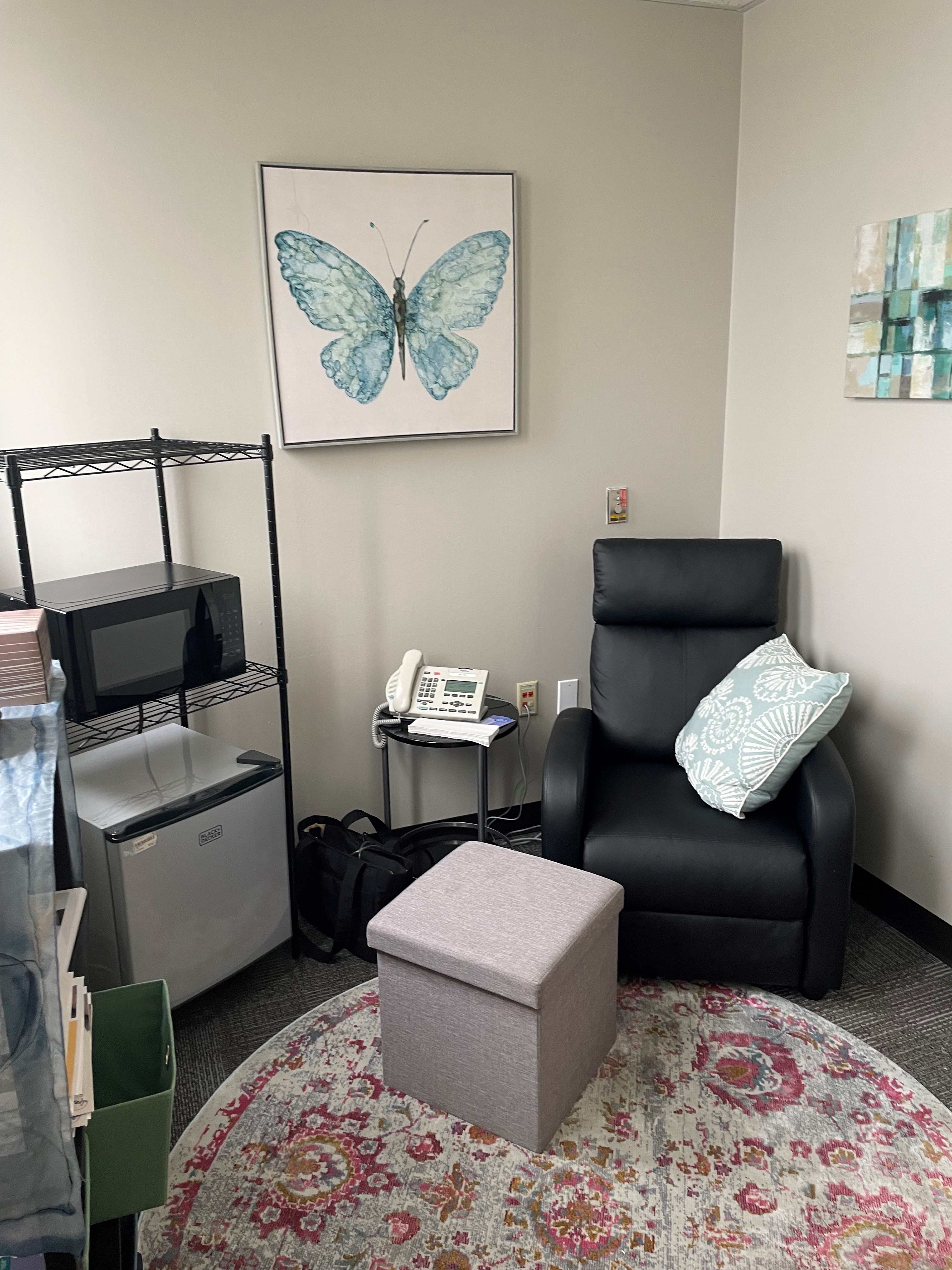 Photo of lactation room with small fridge and recliner