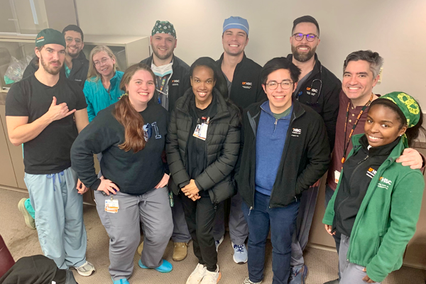 Group of residents in an indoor setting (some in scrubs)