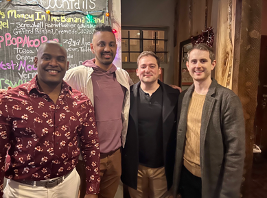 Four faculty at the holiday party