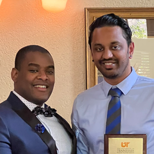 Program director and Dr. Venigalla holding his resident of the year award