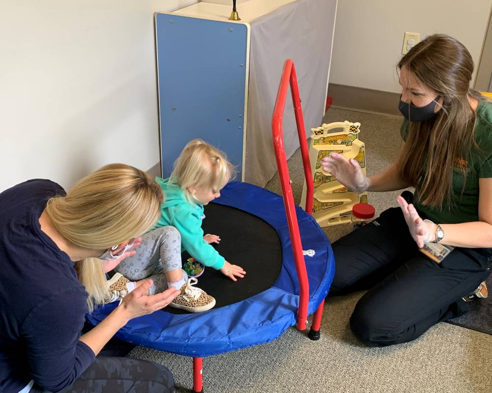 therapy with child on mini trampoline