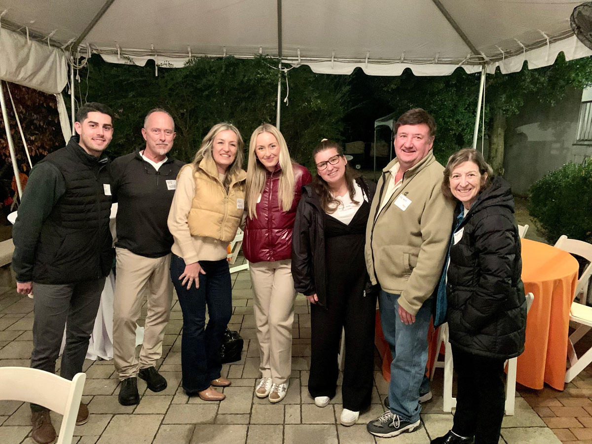 Family Weekend and Alumni Homecoming 2023 photo of a group of alum outside under a tent.