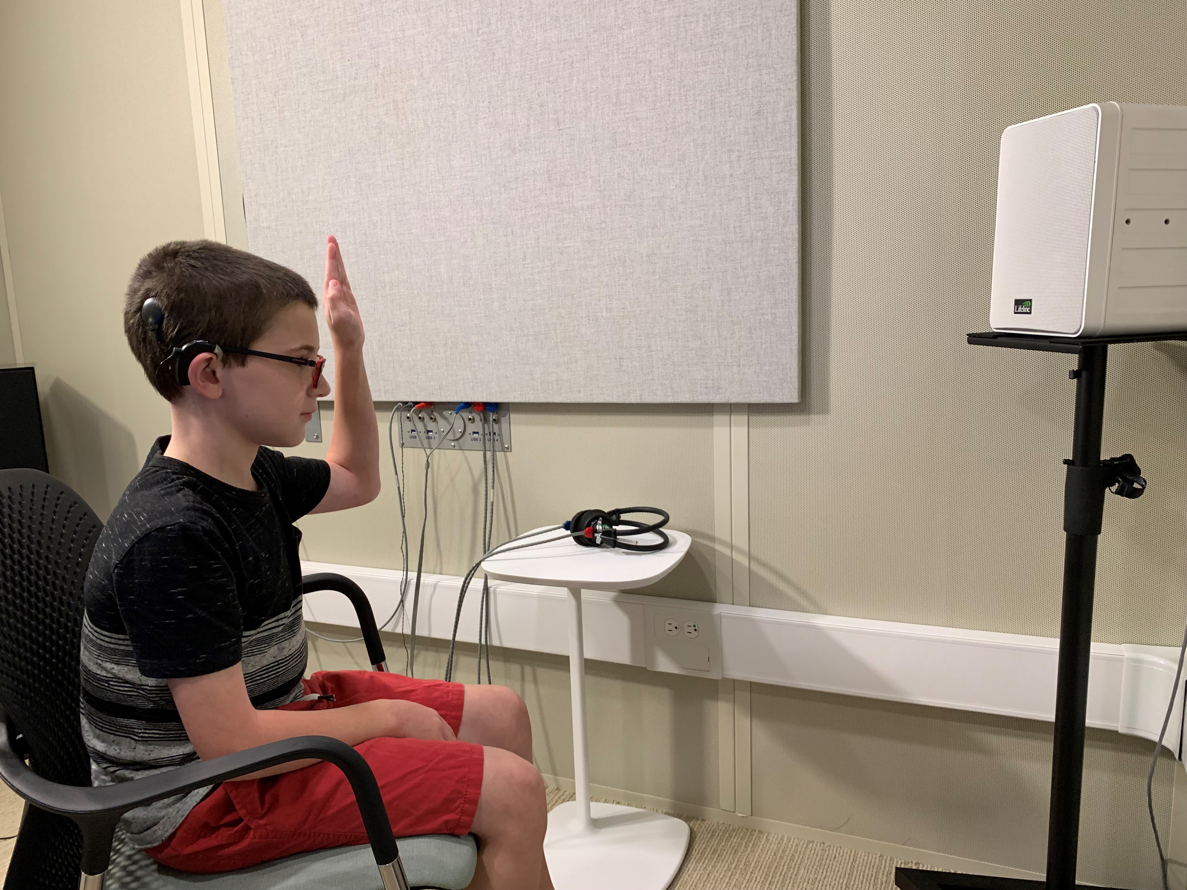 Patient raises hand during examination