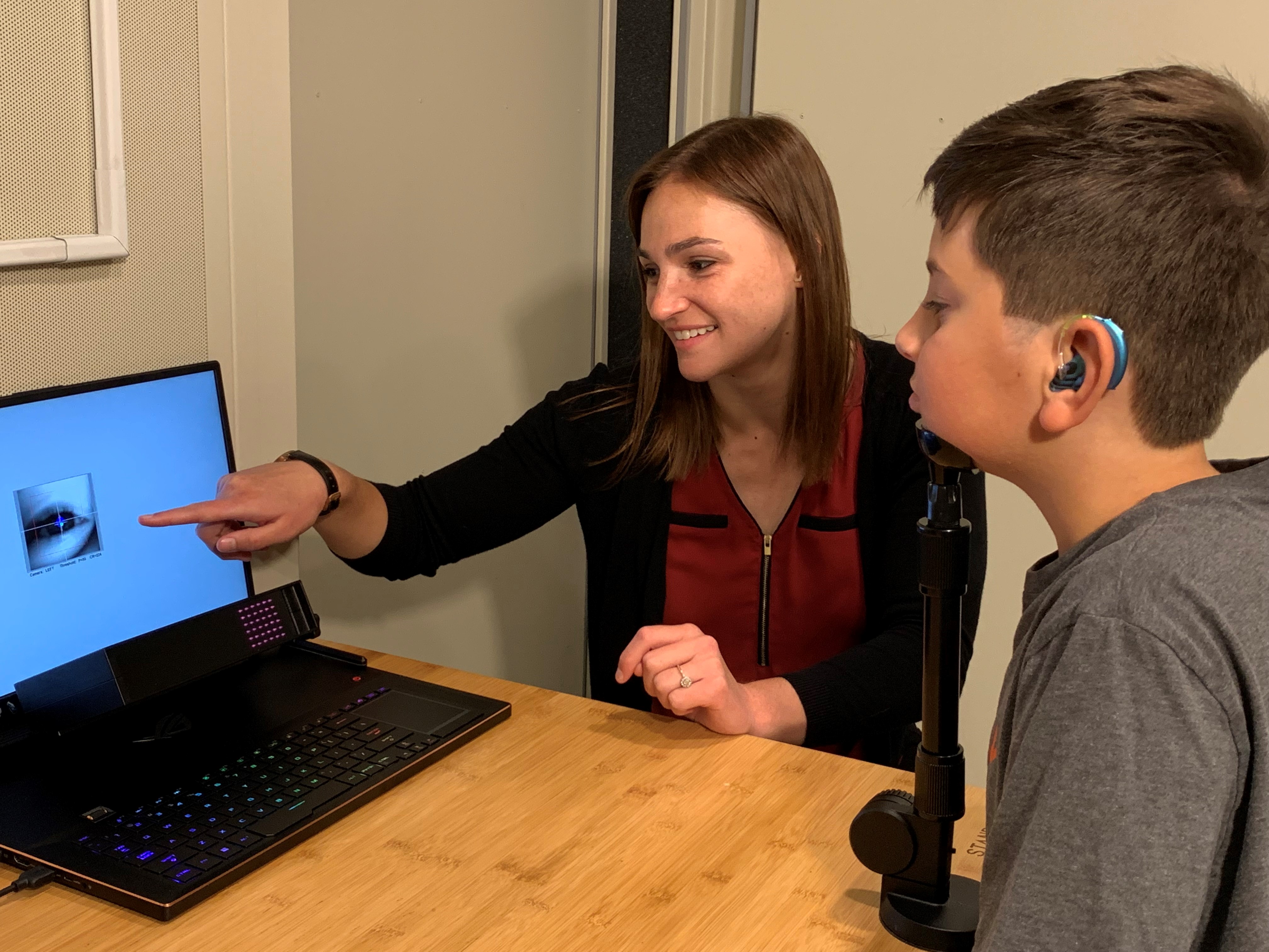 Dr. Klein pointing to computer screen with patient