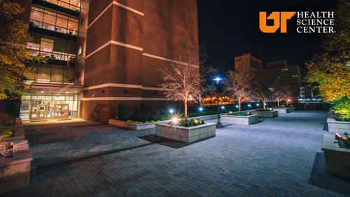 UTHSC Zoom/Teams background Pharmacy building at night.