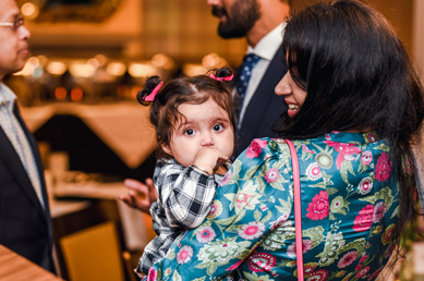 Baby girl held by an attendee at the graduation