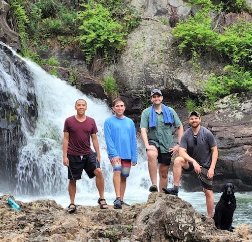 Residents standing in front of a waterfall in Cohutta Wilderness