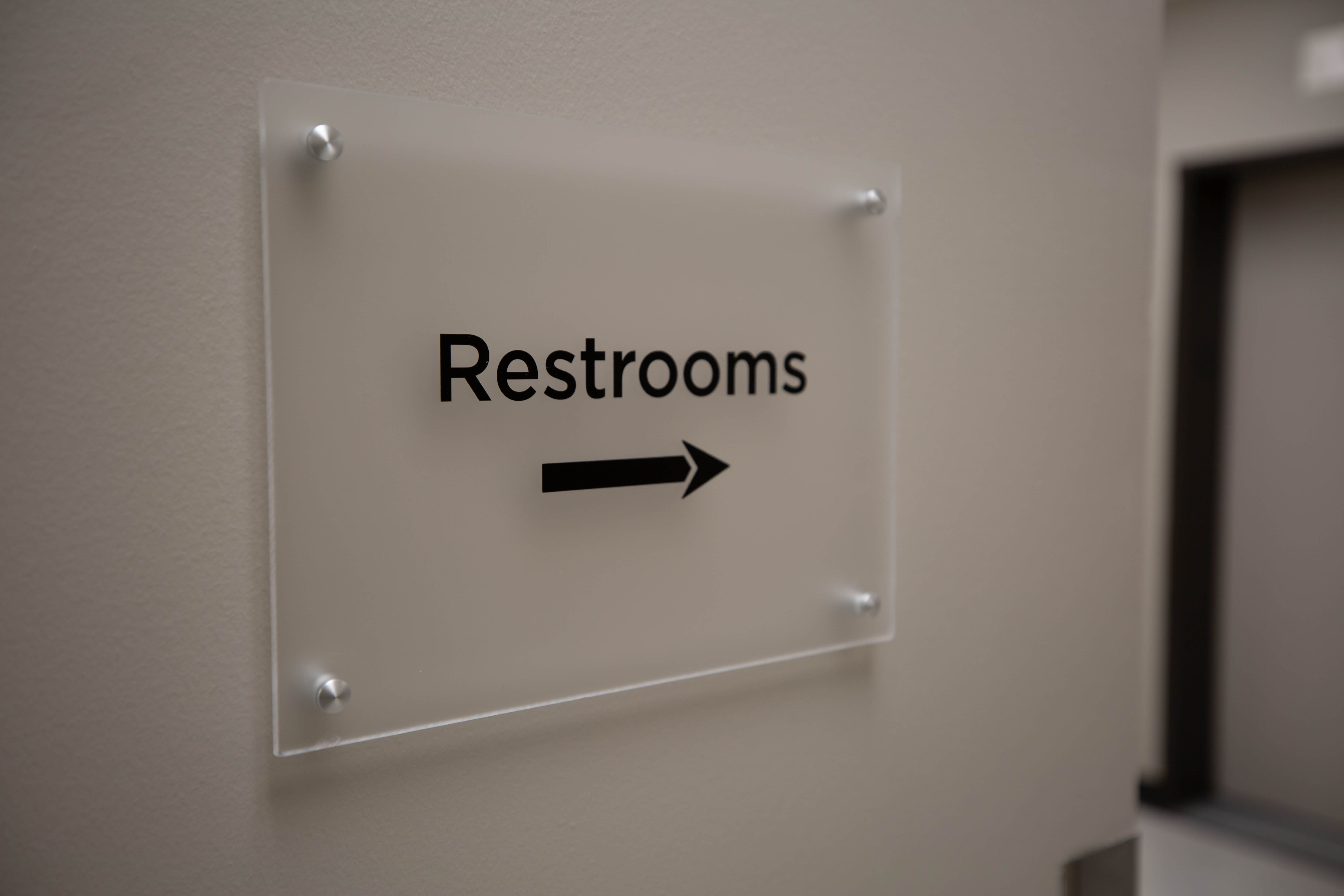 directional sign pointing to restrooms