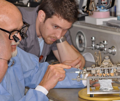 Colleagues discuss in Prosthodontics lab.