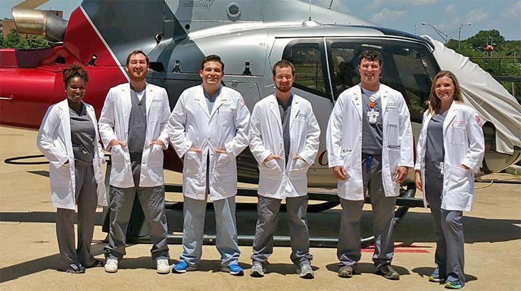 Residents in front of an emergency helicopter