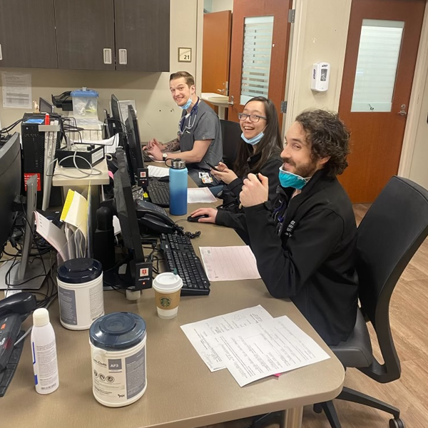 Residents sitting in an office in front of computers