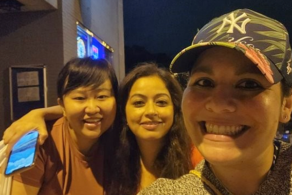 three female residents outside at night