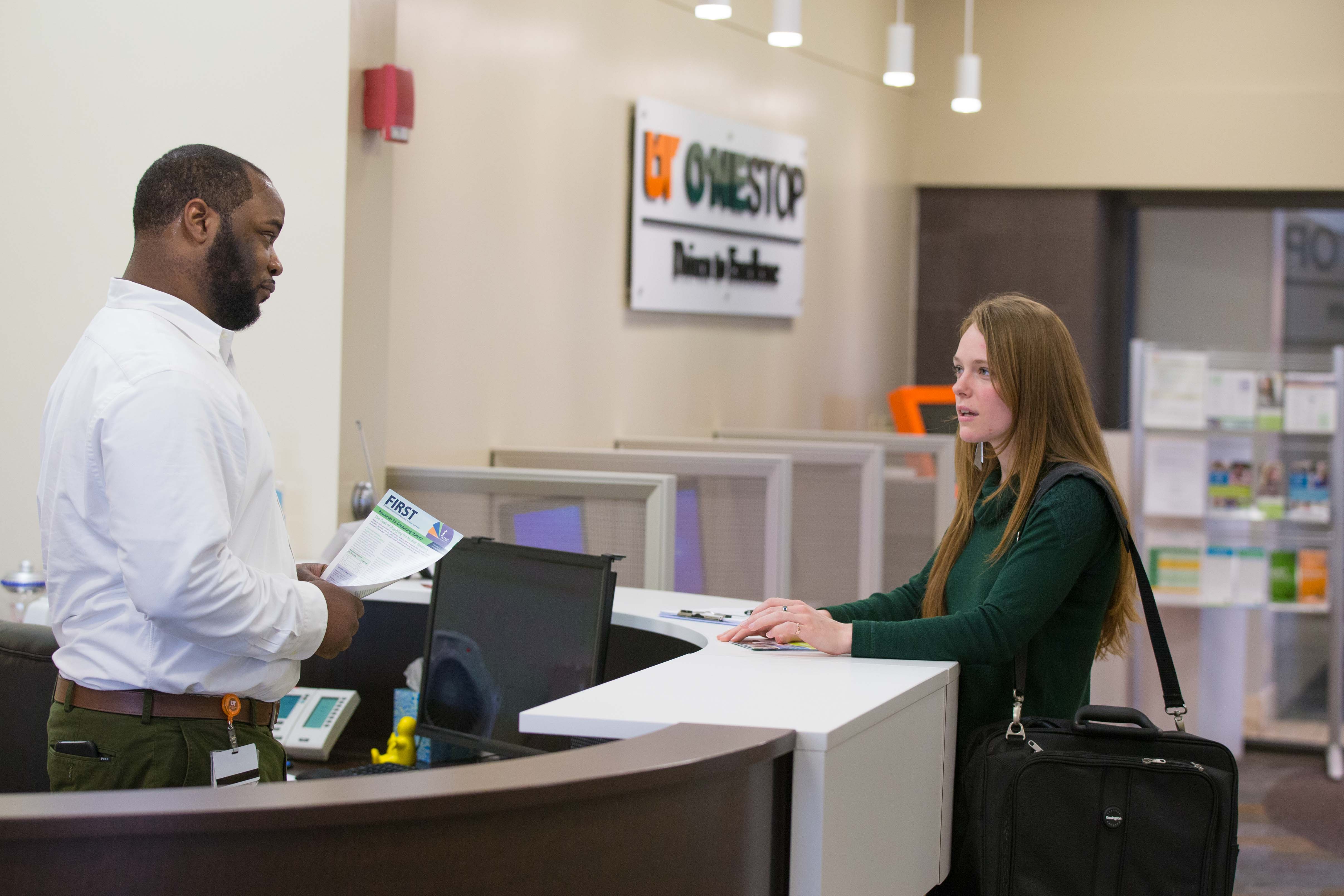 Student discussing financial aid with a ONESTOP staff member