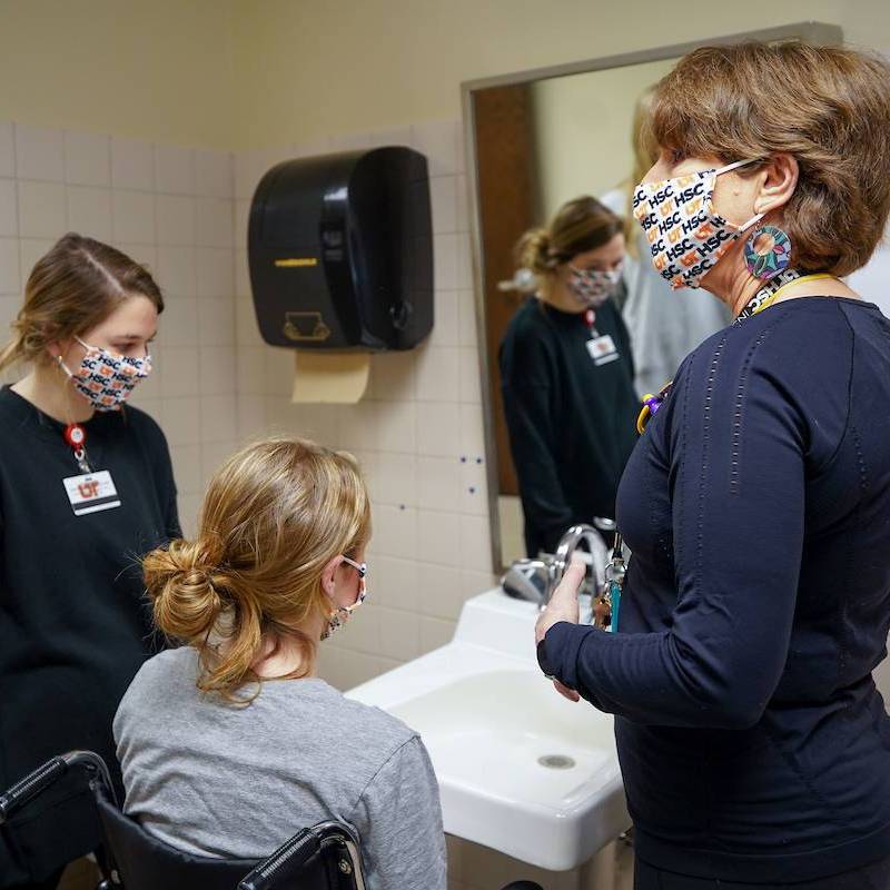 occupational therapy lab with students learning from faculty member