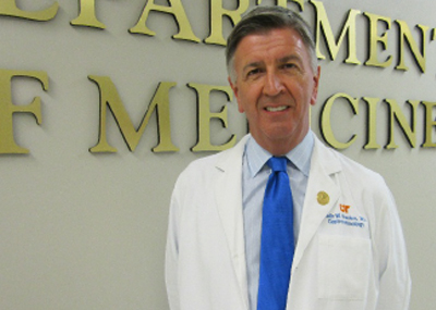 Dr. Howden in the hallway before an Internal Medicine sign.