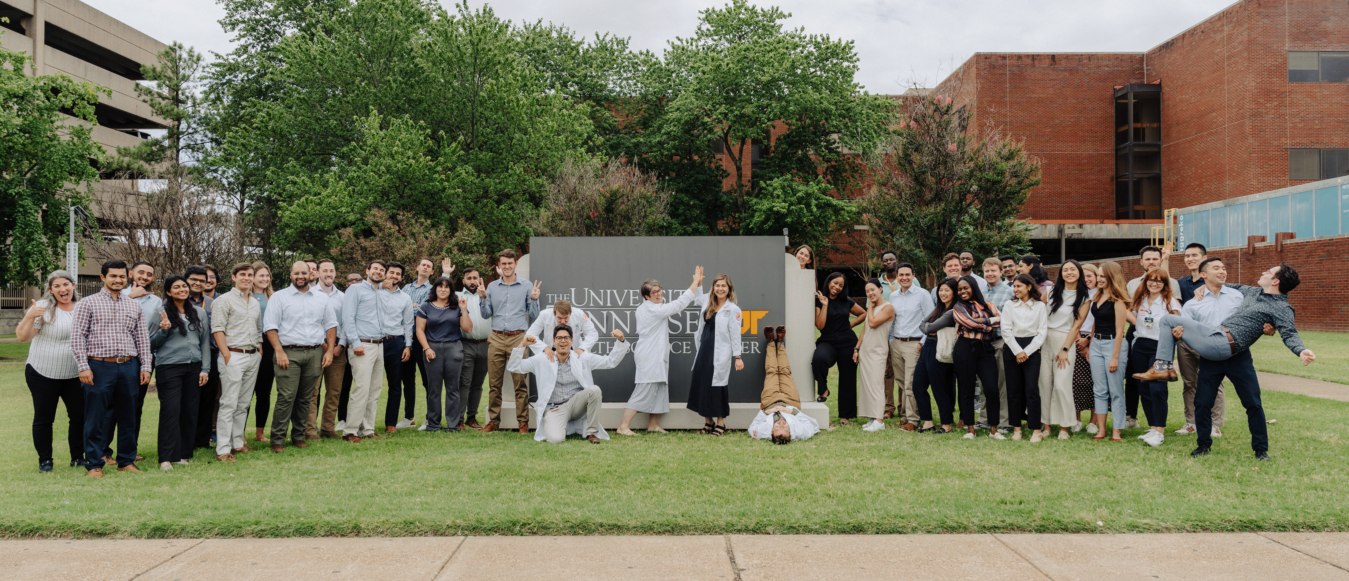 image of residents in front of an outdoor UTHSC sign