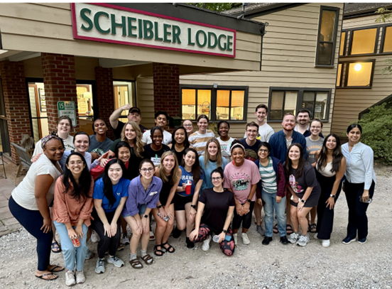 Residents posing in front of a lodge