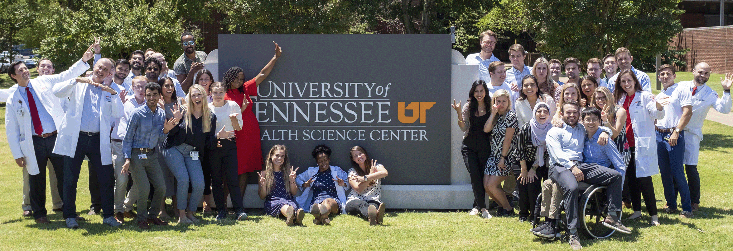 image of residents in front of an outdoor UTHSC sign