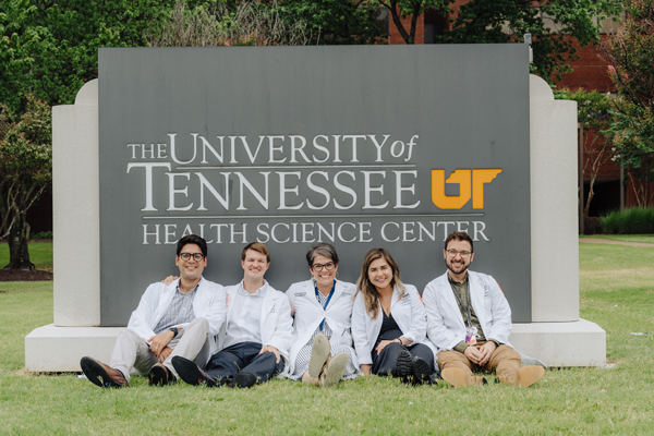 Chiefs and program director in front of a UTHSC sign