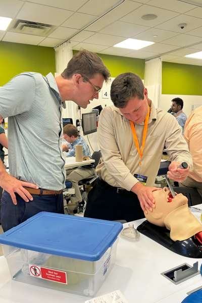Residents working on a sim dummy