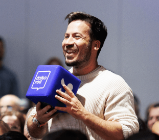 A man speaks into a Catchbox throwable microphone