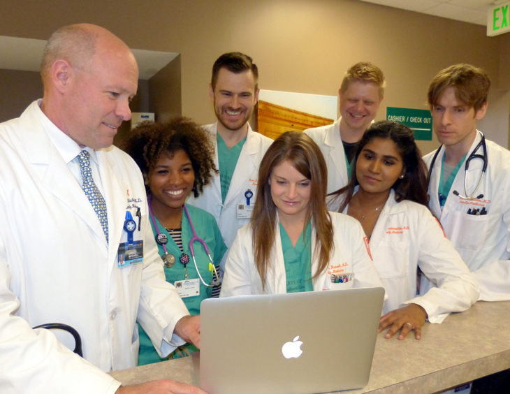 Dr. Mitchell in a hospital setting with residents