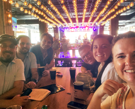 Six residents indoors at a booth in a restaurant