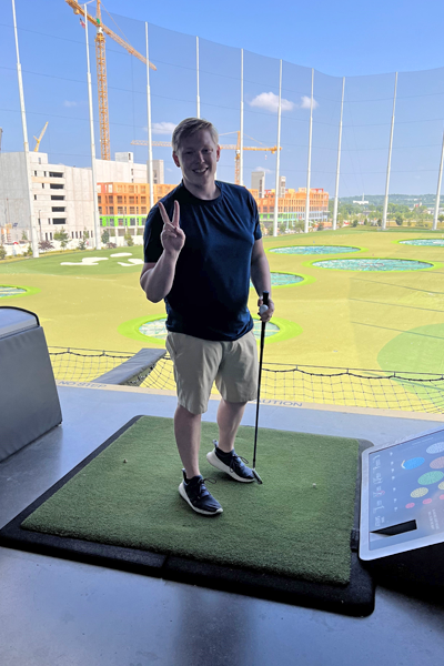 Resident on the driving range giving a peace sign