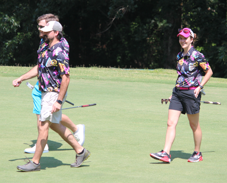 Residents walking on the golf course with gold clubs