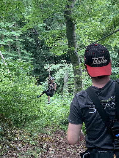 Residents swinging from tree outdoors