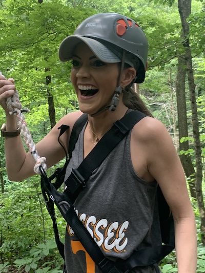 Female resident outdoors with ziplining gear on