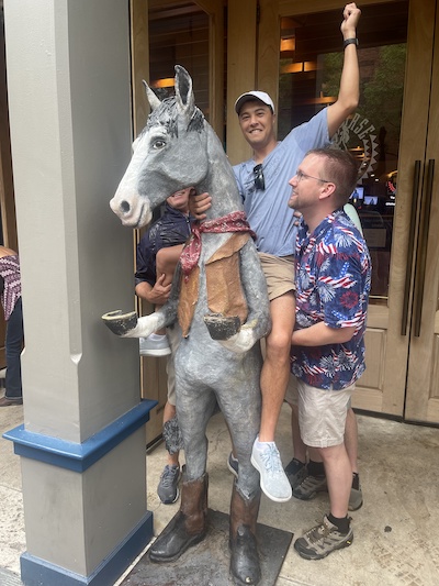 Resident outdoors riding a horse statue