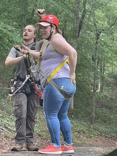 Resident outdoors getting ready to zipline
