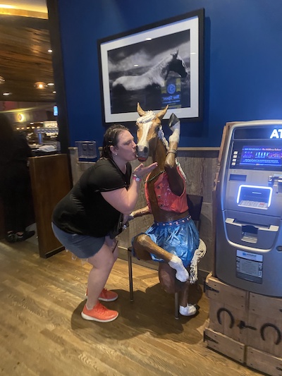 Resident indoors kissing a horse statue