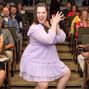 Resident walking the aisle at graduatoin