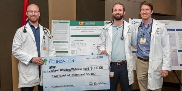 Residents and faculty with a big check