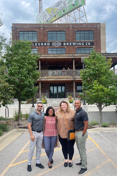 Residents outside in front of an old brewery building