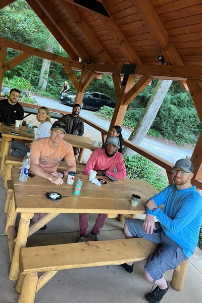 residents sitting outside at a picnic table