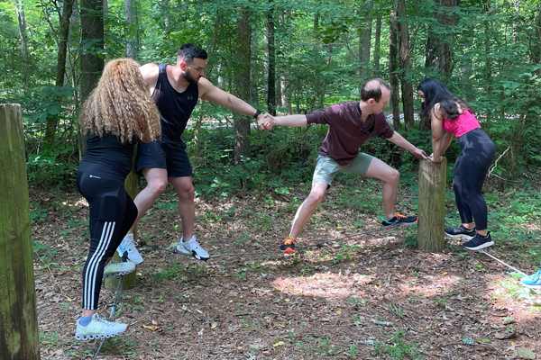 residents outside on a ropes course