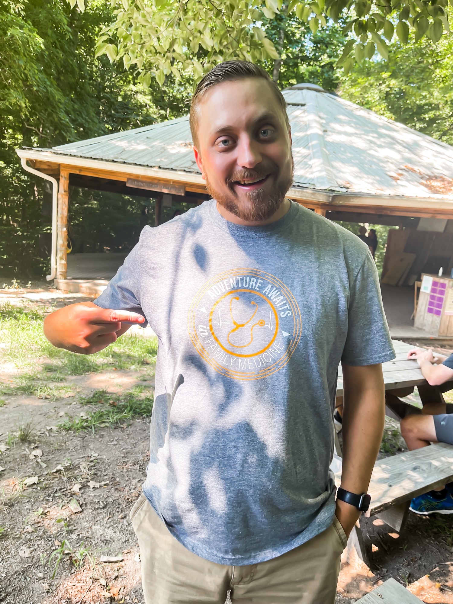 Resident pointing to his shirt logo