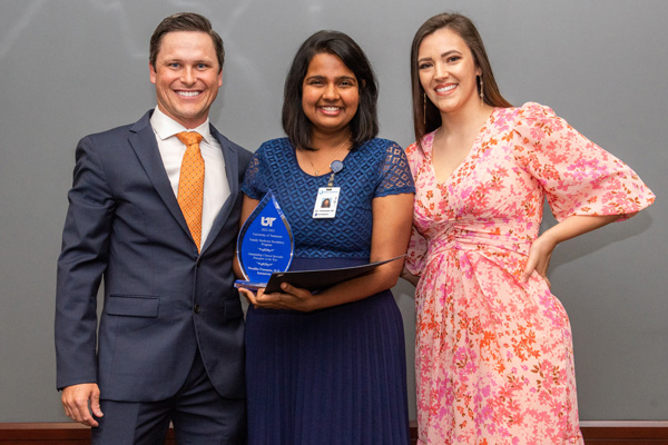 Faculty presenting resident with award