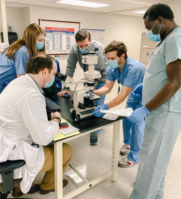 Residents looking at blood smears