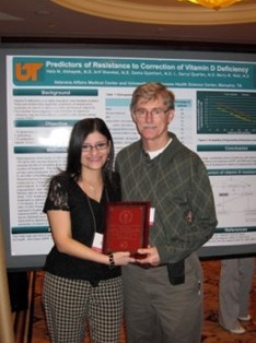 Dr. Alshayeb with Dr. Wall holding an award