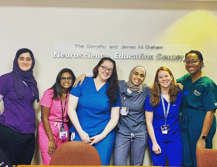 Six female residents in the hallways of the Neuroscience Education Center